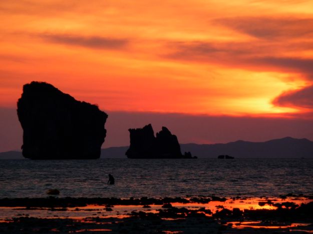 sunset thailand chicken island with swimmer
